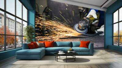 Grinding a piece of metal pipe and producing sparks. Wall mural