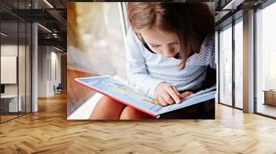 toddler girl with book Wall mural