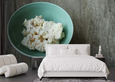 cottage cheese in a green plate is on the table Wall mural