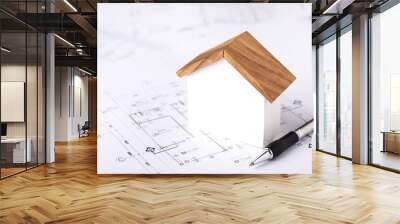 Concept of building permit application, featuring a house model and construction plans placed on a table, symbolizing the process of planning and approval for home construction Wall mural