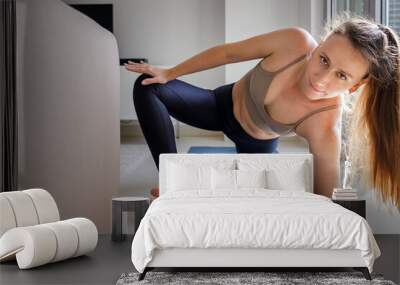 Close up image of young woman doing yoga at home Wall mural