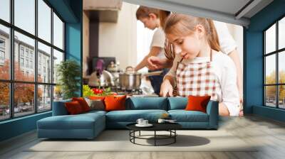 Family cooking. Mum and children in the kitchen Wall mural