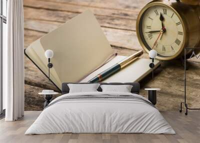 Open notebook with fountain pen and alarm clock Wall mural