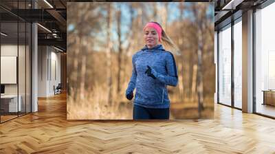 Portrait of running woman in autumn park Wall mural