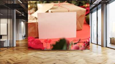 Christmas gift boxes with blank card for design on red background. Christmas presents with decoration. Christmas, New Year, shopping, preparation on Holidays, donation concept, sale. Mock up Wall mural