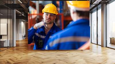 A team of engineers meeting to inspect computer-controlled steel welding robots. Plan for rehearsals and installation for use. Wall mural