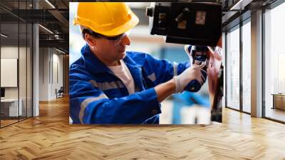 A team of engineers meeting to inspect computer-controlled steel welding robots. Plan for rehearsals and installation for use. Wall mural