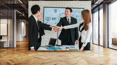 Asian business team show unity with their hands in the office meeting room for assigned tasks that must be accomplished together Wall mural