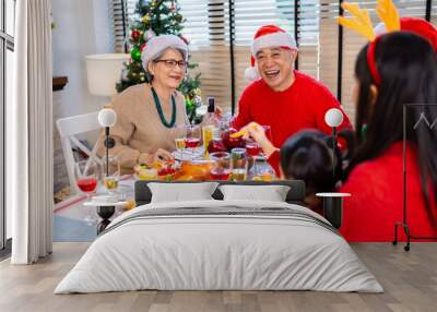 Asian family on Christmas Day. Everyone is happy together in a Christmas themed room filled with presents and orange lights. Wall mural