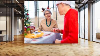 Asian family on Christmas Day. Everyone is happy together in a Christmas themed room filled with presents and orange lights. Wall mural