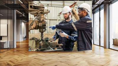 Team of engineers practicing maintenance Taking care and practicing maintenance of old machines in the factory so that they can be used continuously. Wall mural