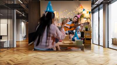 Two Asian women in room with Ciematic lighting celebrate important events such birthdays Christmas Wall mural