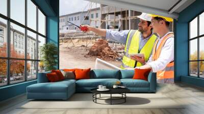 Two civil engineers man inspecting  construction of house in village that they responsible for outdoors for construction of residential houses to be in accordance with standards and strong Wall mural