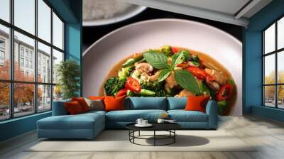 A sizzling plate of stir-fried broccoli and pork, seasoned with a blend of aromatic spices and a savory sauce. A healthy and flavorful dish perfect for any meal. Wall mural