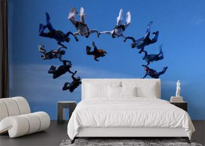 Formation skydiving. A group of skydivers is in the amazing sky. Wall mural