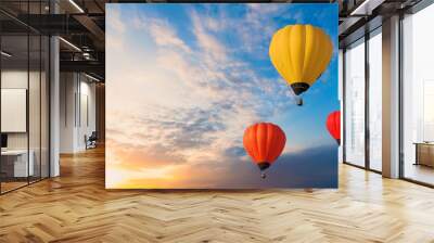 Colorful balloons floating in the sky at sunset. Wall mural