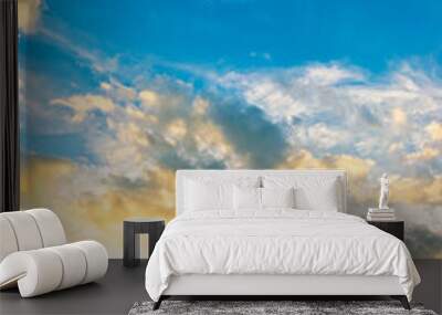 vertical Sky blue and orange light of the sun through the clouds in the sky Wall mural