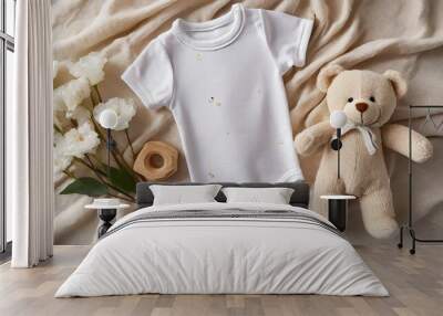 white cotton baby short sleeve bodysuit teddy bear and natural wooden toy on beige blanket throw background infant onesie mockup blank gender neutral newborn bodysuit mock up template top view Wall mural