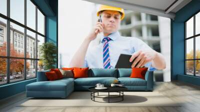 engineer with a telephone and a digital tablet Wall mural