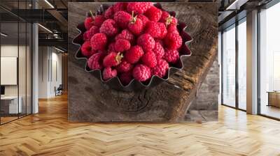 Raspberry. Fresh juicy berries from the garden in an iron pot on a wooden table. Raspberry With green leaves. Fresh organic berries macro View from above. Top view. Close-up photo. Wall mural