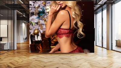 gorgeous woman with blond hair in lingerie , posing near Christmas tree Wall mural