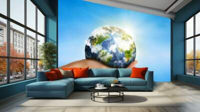 hand holding globe over blue sky - elements of this image furnis Wall mural