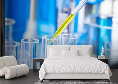 A pipette dropping sample into a test tube,abstract science background Wall mural