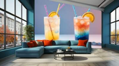 A colorful glass of iced drink with ice cubes and a blue straw against a pastel gradient background Wall mural