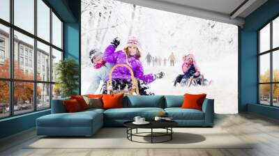 Happy family winter fun outdoors. Active parents with kids runni Wall mural