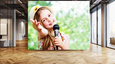 pretty little girl with the microphone in her hands - outdoor Wall mural