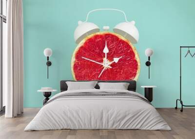 Creative idea layout fresh grapefruit slice alarm clock on pastel blue background. minimal idea business concept. fruit idea creative to produce work within an advertising marketing communications Wall mural