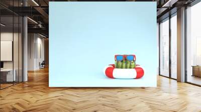 Creative summer layout made of  watermelon with red pool float and sunglasses on blue pastel background. minimal fruit concept idea. Wall mural