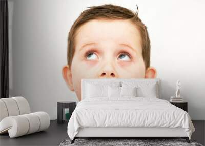 handsome little boy eating a fresh cream cup cake with messy fac Wall mural