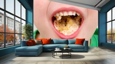 handsome little boy eating a fresh cream cup cake with messy fac Wall mural