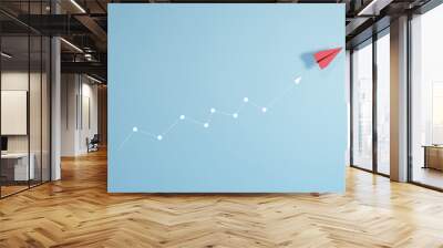 Red paper plane isolated on blue background, concept of volatility in business and investment, graph with arrow up Wall mural