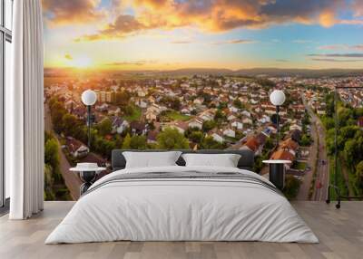 Aerial panorama of a small town at sunrise, with magnificent colorful sky and warm light Wall mural