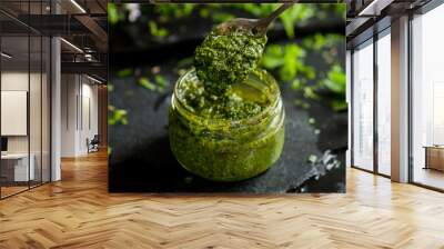 pesto sauce in a spoon, jar with pesto sauce Wall mural