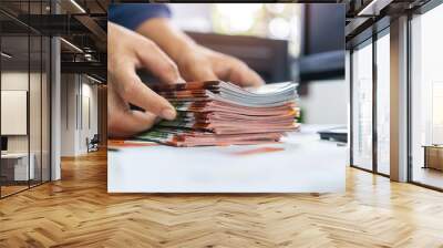 Pile of presentation brochure document concept : Businessman hands working in business Documents on Stacks Brochures papers files for checking achieves reports on busy work computer desk office Wall mural