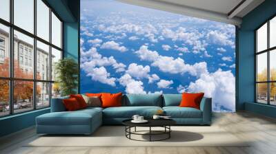 Sky scape cloudscape from aerial airplane shot of blue clouds. View flying above moutain from windows over Loei, Thailand. Wall mural