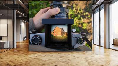 man photographer is making architecture photography with old film  camera Wall mural