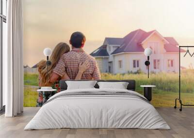 Young Couple Standing Outside Dream Home Wall mural