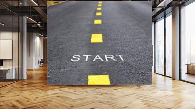 Words of start with yellow line marking on road surface in the park, transportation concept and business idea Wall mural