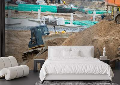 bulldozer conducting excavation works in the pit on a large cons Wall mural