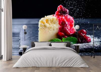 cherry cheesecake on a black background with reflection and flying icing sugar Wall mural