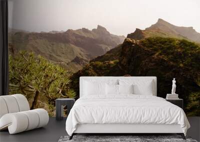 Legs of traveler sitting on a high mountain top in travel. Freedom concept. Tenerife Wall mural