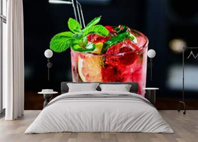 Raspberry pink Mojito Lemonade with lime and fresh mint in glass on bar counter in a nightclub. Summer refreshing cocktail. Wall mural