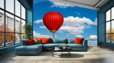 Red hot air balloon in blue cloudy sky Wall mural