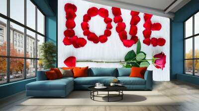 Red rose petals set in word LOVE and arrow Wall mural