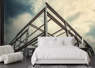 Structural Steel Framework Under Cloudy Sky Architectural Engineering and Construction Concept Wall mural