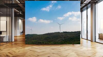 The windmills on the top of a mountain. They generate green energy from the nature. Wall mural